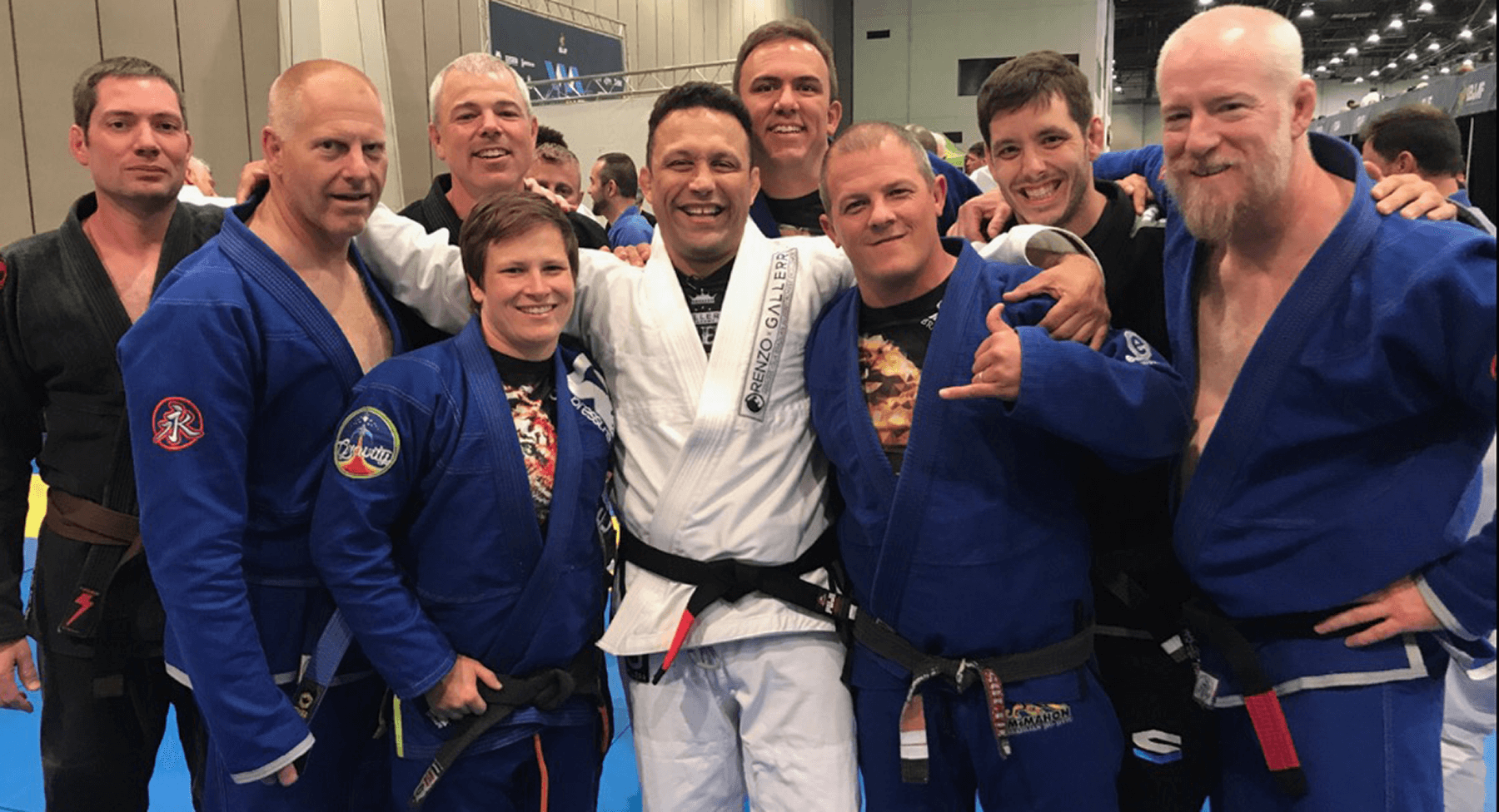 renzo-gracie-jiu-jitsu-team 9 jiu jitsu practioners from right to left, rob, bill, julie, nate, renzo gracie, jamis, finnie mcmahon, bruce, garry